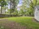 Expansive backyard featuring a wooden fence, established trees, and a lush lawn, ideal for outdoor activities at 1617 E 52Nd St, Indianapolis, IN 46205