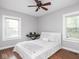 Bedroom with hardwood floors, two windows, and a ceiling fan at 1617 E 52Nd St, Indianapolis, IN 46205