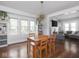 Dining room view with hardwood floors, modern light fixture, and view to living room at 1617 E 52Nd St, Indianapolis, IN 46205