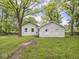 Exterior view of home showcasing white stone details, set in a lush green lawn at 1617 E 52Nd St, Indianapolis, IN 46205