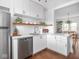 Kitchen with stainless steel appliances, white countertops, open shelving, and modern fixtures at 1617 E 52Nd St, Indianapolis, IN 46205