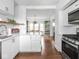 Open kitchen and dining room view featuring stainless steel appliances, hardwood floors, and bright light at 1617 E 52Nd St, Indianapolis, IN 46205