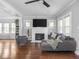 Bright living room with modern gray furnishings, fireplace, and gleaming hardwood floors at 1617 E 52Nd St, Indianapolis, IN 46205
