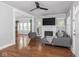 Bright living room with modern gray furnishings, fireplace, and gleaming hardwood floors at 1617 E 52Nd St, Indianapolis, IN 46205