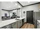 Stylish kitchen featuring a white quartz countertop, stainless steel appliances, and adjacent lounge area at 17233 Gunther Blvd # 102B, Westfield, IN 46074