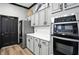 Modern kitchen with stainless steel appliances, sleek cabinets, and an adjacent black door at 17233 Gunther Blvd # 102B, Westfield, IN 46074