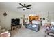 Inviting living room with a ceiling fan, and open access to the adjacent dining and kitchen areas at 17233 Gunther Blvd # 102B, Westfield, IN 46074