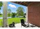 Charming patio with brick exterior, scenic water views, and cozy seating at 17233 Gunther Blvd # 102B, Westfield, IN 46074