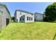 Spacious backyard with lush green lawn, fenced perimeter, and bright sunroom addition at 18726 Tillamook E Run, Noblesville, IN 46062