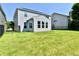 Manicured backyard features lush lawn, privacy fence, and bright sunroom addition at 18726 Tillamook E Run, Noblesville, IN 46062