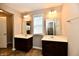 Bright bathroom featuring dual sinks with dark wood cabinets and tile flooring at 18726 Tillamook E Run, Noblesville, IN 46062