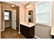 Well-lit bathroom featuring a single sink, tile floor and a large vanity mirror at 18726 Tillamook E Run, Noblesville, IN 46062