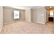 Empty bedroom featuring plush carpet, a window, and ensuite bathroom access at 18726 Tillamook E Run, Noblesville, IN 46062