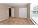 Neutral bedroom with carpet, a window with blinds, and a closet with bi-fold doors at 18726 Tillamook E Run, Noblesville, IN 46062