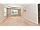 A spacious carpeted bedroom with ample natural light from two large windows at 18726 Tillamook E Run, Noblesville, IN 46062