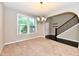 Bright dining room with large windows, access to the front door, and a view of the staircase at 18726 Tillamook E Run, Noblesville, IN 46062