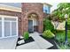Arched brick entryway leading to a charming front door, framed by lush landscaping at 18726 Tillamook E Run, Noblesville, IN 46062