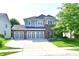 Beautiful two-story home with a three car garage, brick accents, and manicured lawn at 18726 Tillamook E Run, Noblesville, IN 46062