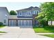 Charming two-story home with a three-car garage, well-kept lawn, and appealing brick and siding exterior at 18726 Tillamook E Run, Noblesville, IN 46062