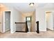 Upstairs hallway with neutral carpet, decorative banister, and natural lighting at 18726 Tillamook E Run, Noblesville, IN 46062
