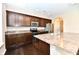 Modern kitchen showcasing dark wood cabinetry, stainless steel appliances, and laminate countertops at 18726 Tillamook E Run, Noblesville, IN 46062