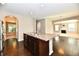 Kitchen island with stainless steel appliances, granite countertops, and brown cabinetry at 18726 Tillamook E Run, Noblesville, IN 46062