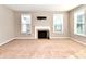 Bright living room featuring large windows, neutral carpet, and fireplace at 18726 Tillamook E Run, Noblesville, IN 46062