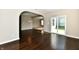 Spacious living area featuring gleaming hardwood floors and a sliding glass door at 18726 Tillamook E Run, Noblesville, IN 46062