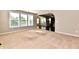 Sunlit living room with large windows and seamless flow to the kitchen and dining area at 18726 Tillamook E Run, Noblesville, IN 46062