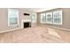 Well-lit living room featuring a fireplace and large windows for ample natural light at 18726 Tillamook E Run, Noblesville, IN 46062