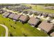 Aerial view displaying the home's placement within the neighborhood with a pond in the background at 19581 Sumrall Pl, Westfield, IN 46074