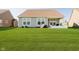 Spacious backyard featuring a well-maintained lawn, patio, and lush green grass at 19581 Sumrall Pl, Westfield, IN 46074