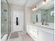 Bright bathroom features a double vanity, framed mirror, glass shower, and neutral wall paint at 19581 Sumrall Pl, Westfield, IN 46074