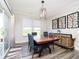 Bright dining room featuring a modern light fixture, sleek furniture, and a sliding glass door at 19581 Sumrall Pl, Westfield, IN 46074