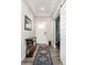 Inviting entryway with stylish runner rug, modern light fixtures, and convenient sliding barn door at 19581 Sumrall Pl, Westfield, IN 46074