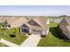 Aerial view showcasing the house's exterior, curb appeal, and the well-maintained front yard at 19581 Sumrall Pl, Westfield, IN 46074