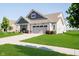 Well-maintained home with lush green lawn, showcasing the home's curb appeal on a sunny day at 19581 Sumrall Pl, Westfield, IN 46074