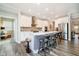 Contemporary kitchen with large island featuring seating, stainless steel appliances, and white cabinetry at 19581 Sumrall Pl, Westfield, IN 46074