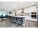 Bright kitchen with a large island, barstool seating, stainless appliances, and modern white cabinetry at 19581 Sumrall Pl, Westfield, IN 46074