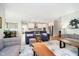 Open-concept living room with hardwood floors flows to a bright kitchen featuring modern decor and furnishings at 19581 Sumrall Pl, Westfield, IN 46074