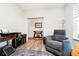 Comfortable living room showcasing a recliner, stylish décor, and a view into the entryway at 19581 Sumrall Pl, Westfield, IN 46074