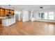 Open-concept kitchen and living area with hardwood floors and modern lighting fixtures at 19987 Old Dock Rd, Westfield, IN 46074