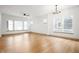 Spacious living room with hardwood floors, a ceiling fan, and large windows for natural light at 19987 Old Dock Rd, Westfield, IN 46074