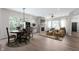 Open-concept living space with a stone fireplace, dining area, and comfortable seating, perfect for entertaining at 19987 Old Dock Rd, Westfield, IN 46074