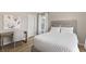 Bright bedroom with a cozy bed, work desk, and plenty of natural light streaming through the window at 2223 Ryder Pl, Westfield, IN 46074
