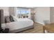 Well-lit bedroom featuring a comfortable bed, stylish lamp, and a large window overlooking the neighborhood at 2223 Ryder Pl, Westfield, IN 46074