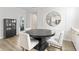 Stylish dining area with modern decor, including a dark table, upholstered chairs, and a decorative mirror at 2223 Ryder Pl, Westfield, IN 46074