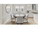 Bright dining area features a modern table, four chairs, and sleek finishes throughout the space at 2223 Ryder Pl, Westfield, IN 46074