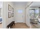 Inviting foyer with wood floors, a sliding barn door, and tasteful decor creating a warm welcome at 2223 Ryder Pl, Westfield, IN 46074