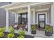 Inviting front porch featuring classic columns, seating, and potted plants, creating a welcoming entrance at 2223 Ryder Pl, Westfield, IN 46074